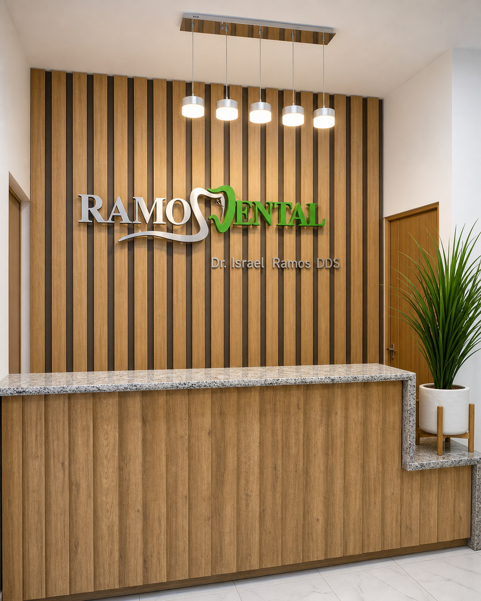 Reception desk and Ramos Dental wall sign at the Nuevo Progreso clinic.