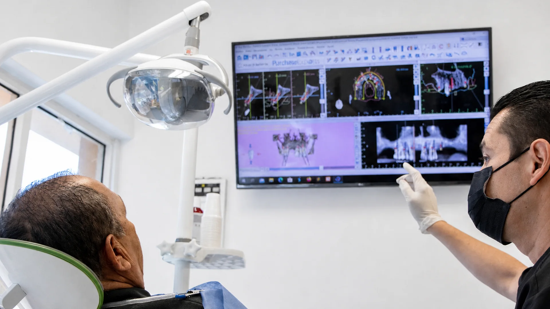 Dr. Israel Ramos explaining digital treatment planning to a patient.