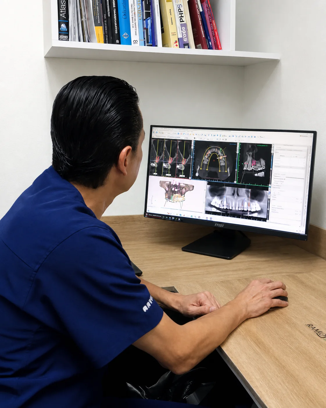 Dr. Israel Ramos reviewing a digital implant plan at a clinical workstation.